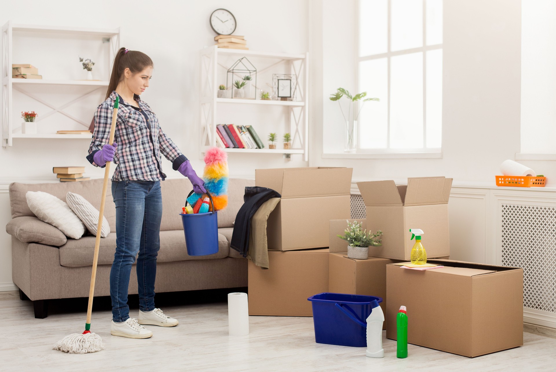 Woman with cleaning equipment ready to clean room